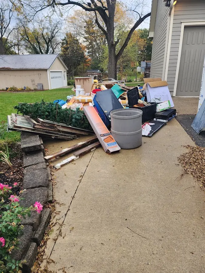 Dumpster being loaded with debris for Residential Dumpster Rental in Southwick